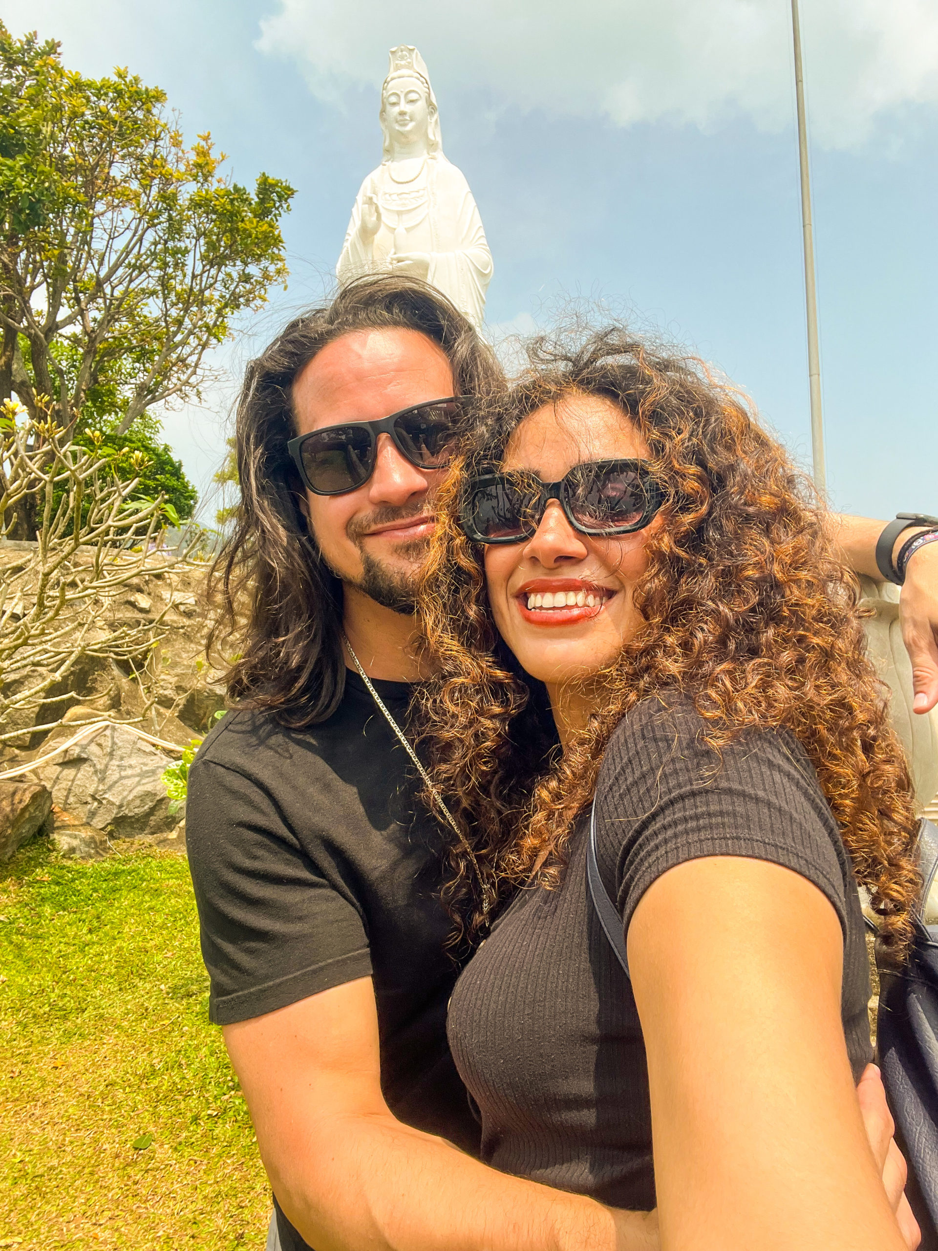 Sara & Eric from Travel Ballad taking a selfie in front of Lady Buddha in Da Nang, Vietnam.